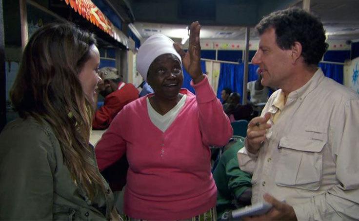 Olivia Wilde and Nick Kristof talk to a Kenyan woman in her restaurant.