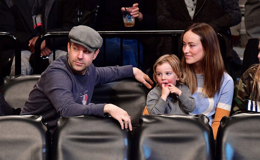 Jason Sudeikis, Otis Sudeikis, and Olivia Wilde attend a basketball game