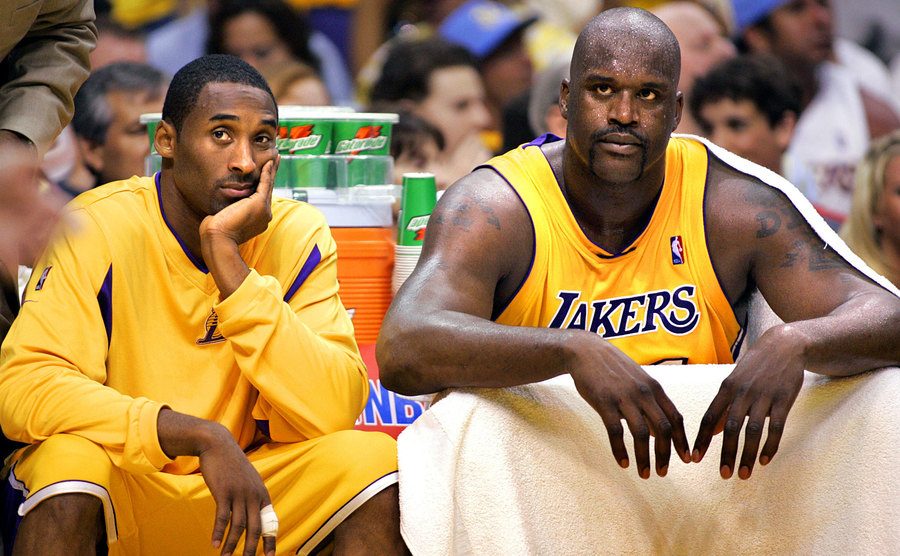 Kobe Bryant and Shaquille O'Neal sit on the bench.