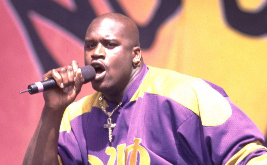 A dated image of O’Neal performing on stage.