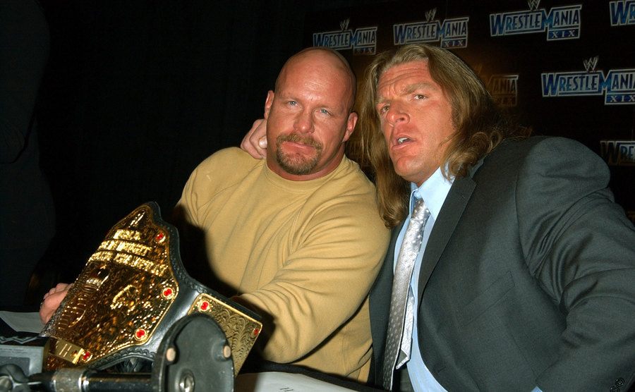 A photo of Steve and Triple H during a press conference.