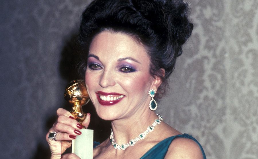 Collins poses with her Golden Globe Award.