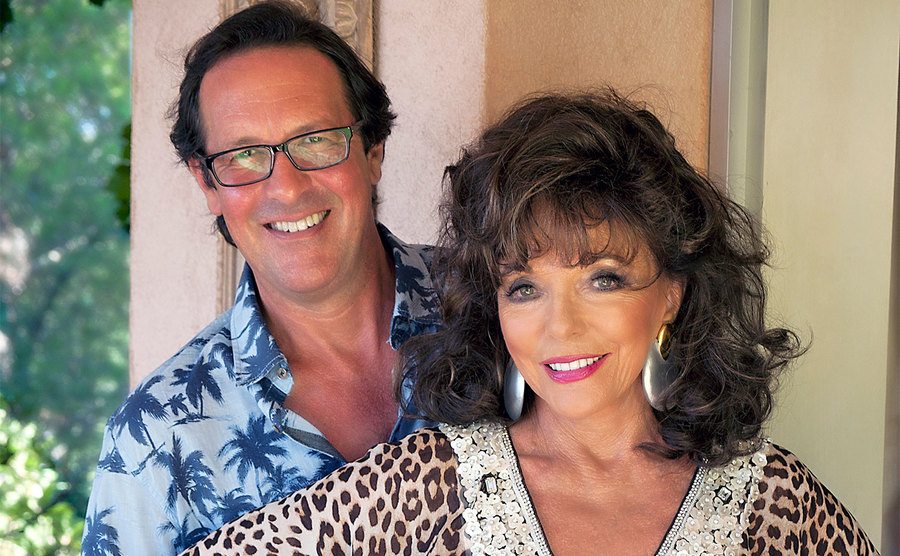 Percy Gibson and Joan Collins pose together.