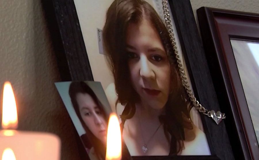 Framed pictures of Cynthia are displayed on a desk surrounded by candles.