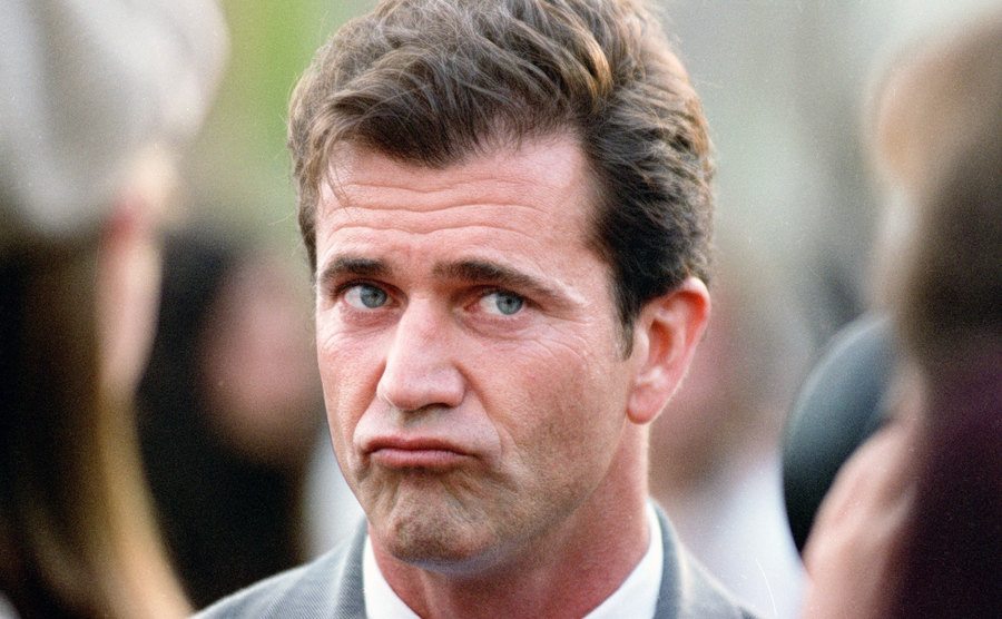 A dated image of Mel Gibson addressing the press.