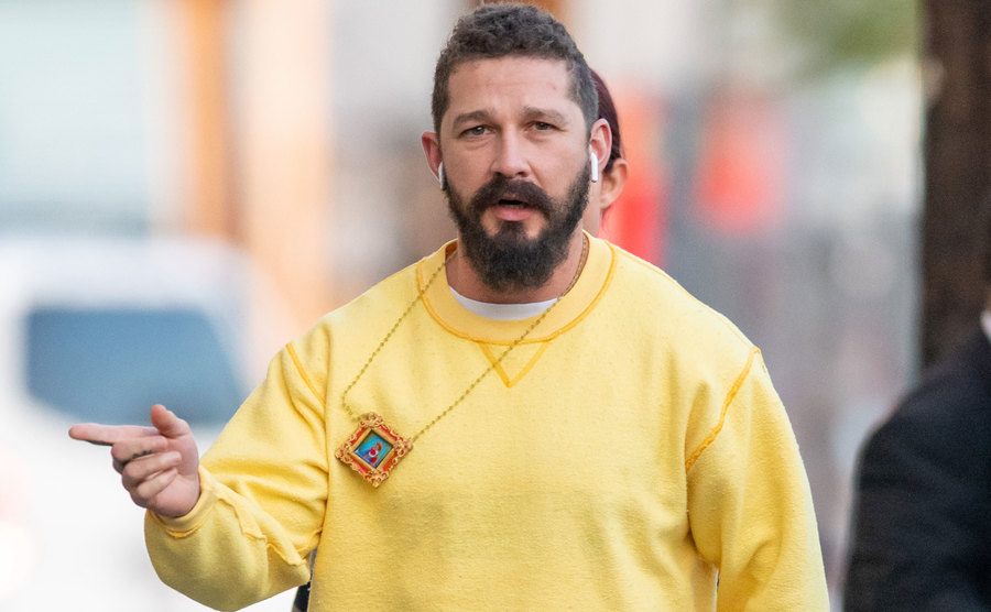 Shia LaBeouf walks the street.