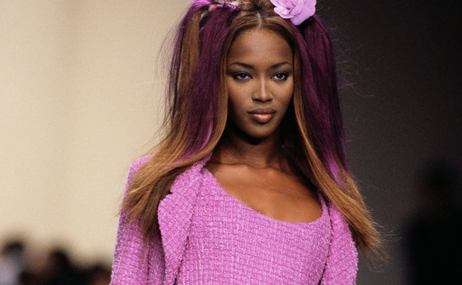 A dated image of Naomi Campbell walking the runway.