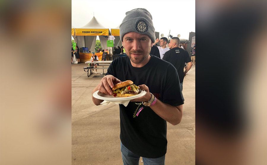 Sean Evans is about to eat a burger. 