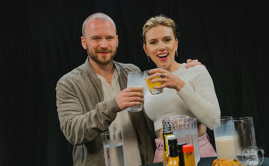 Evans and Johansson clink glasses after filming. 