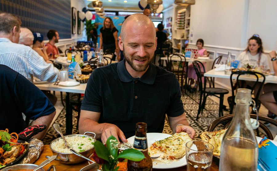 Sean Evans is sitting in a restaurant. 
