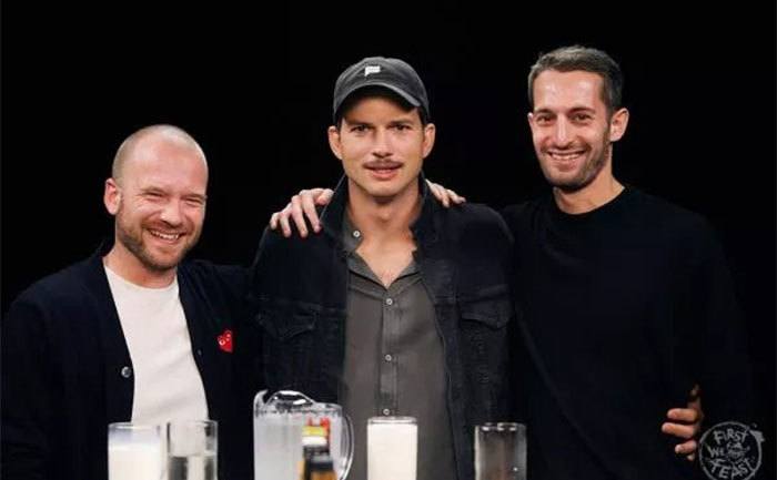 Sean Evans, Ashton Kutcher, and Chris Schonberger pose for a photo. 