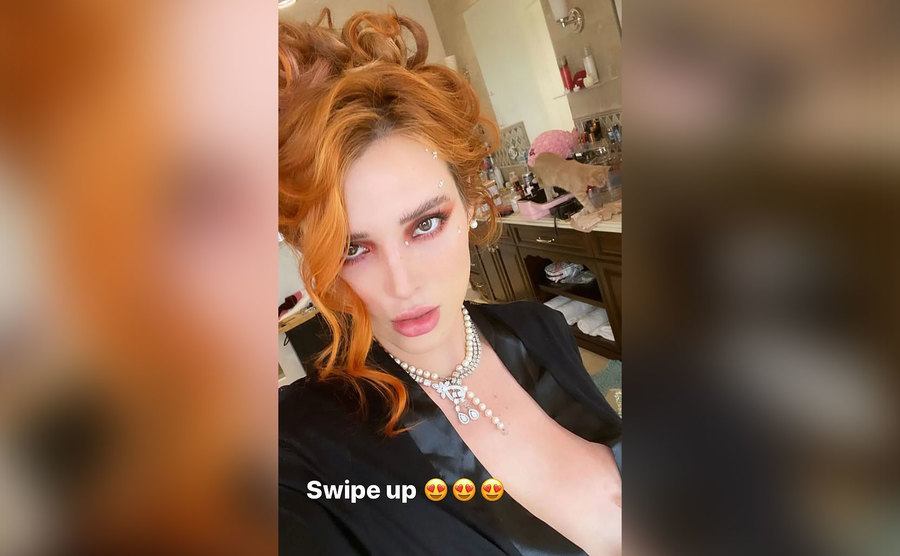 A sultry selfie of Bella Thorne in a robe.