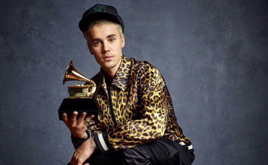 Justin Bieber poses with his Grammy Award.