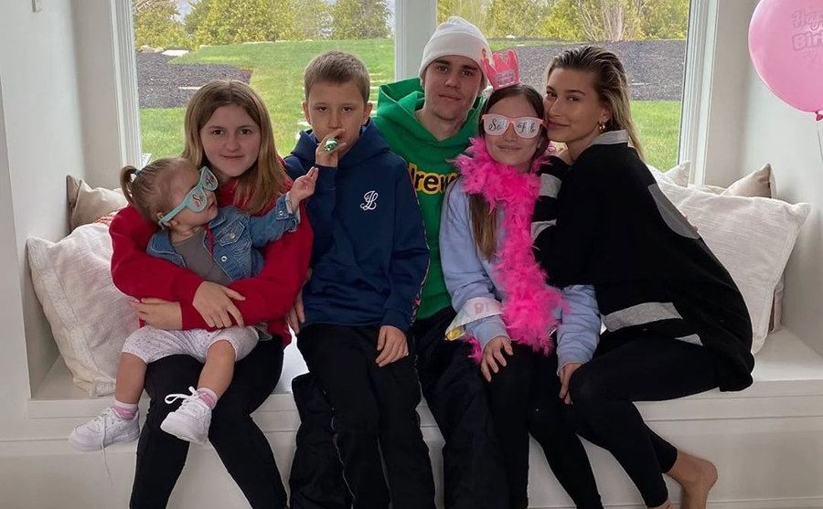 Justin poses with his siblings and his wife.