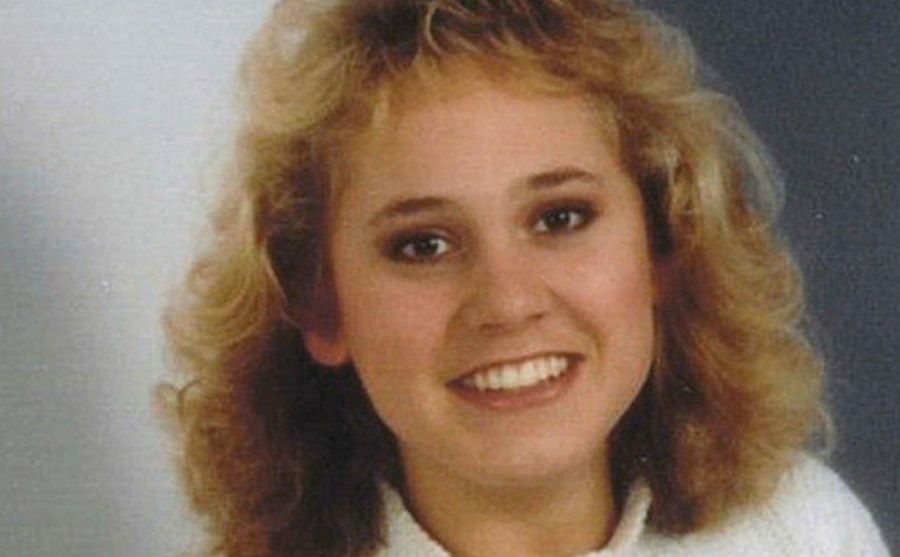 A portrait of Mandy smiling at the camera.