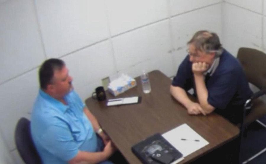 A video still of Tim in the interrogation room.