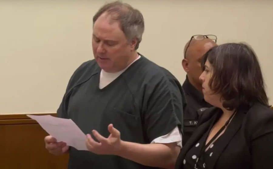 An image of Tim reading a paper in court.