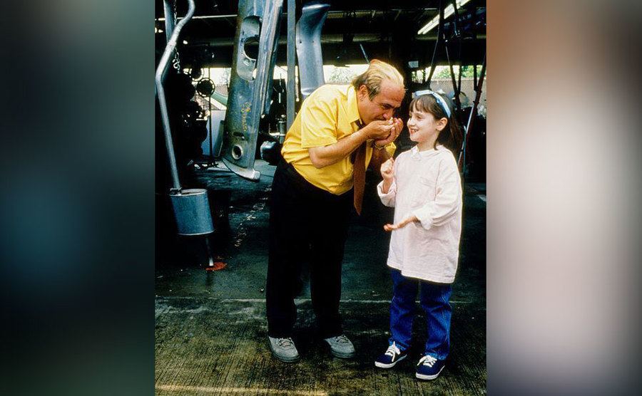 Danny DeVito and Mara Wilson play games on the set of Matilda.