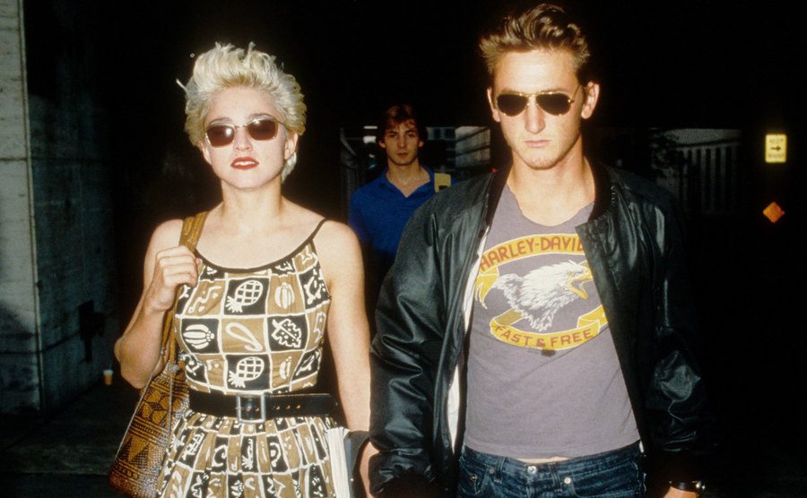 A dated picture of Madonna and Penn walking the street.