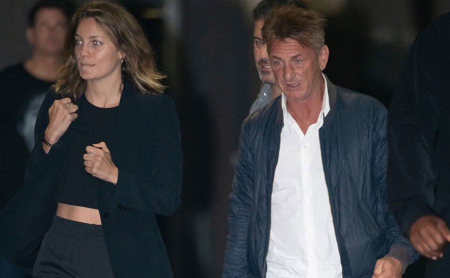 A photo of Leila George and Sean Penn walking the street.