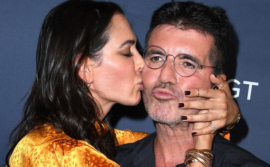 Lauren kisses Simon on a red carpet.