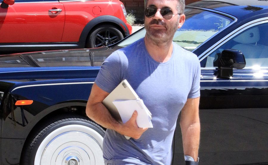 Simon Cowell walks the street.