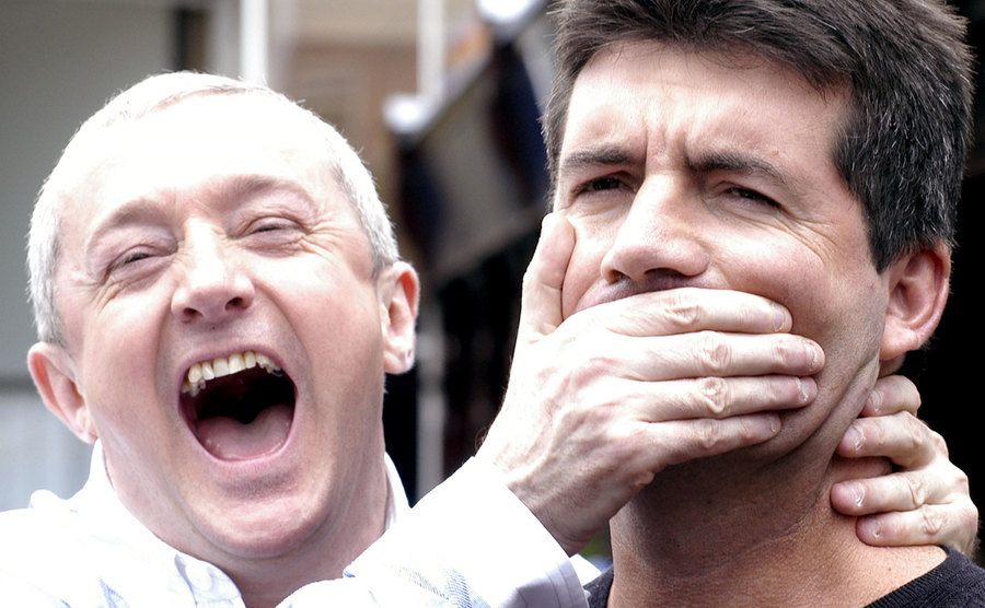 Louis Walsh and Simon Cowell pose for the press.