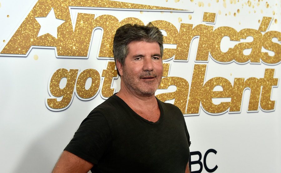 Cowell poses for the press.