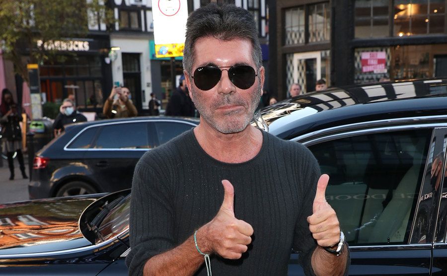 Cowell poses for the press.