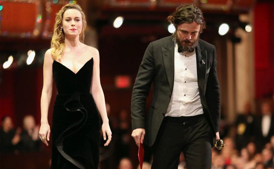 Brie Larson and Casey Affleck walk off stage at the Oscars. 