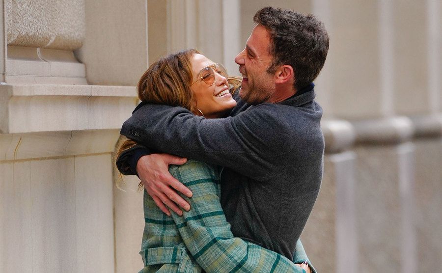 Jennifer Lopez and Ben Affleck hug each other in the street. 