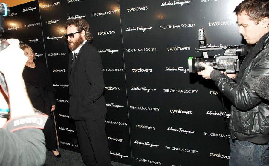 Casey Affleck is filming Joaquin Phoenix on the red carpet. 