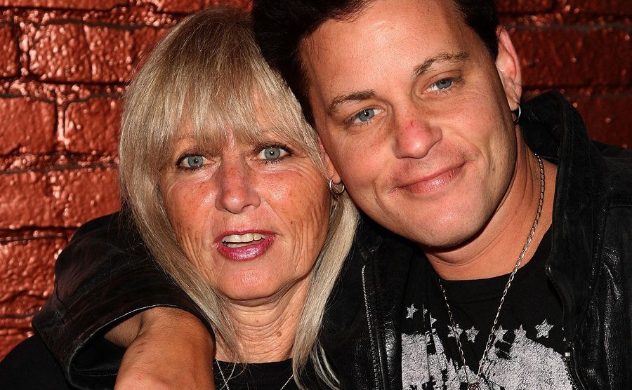 Haim poses, hugging his mother during an event.