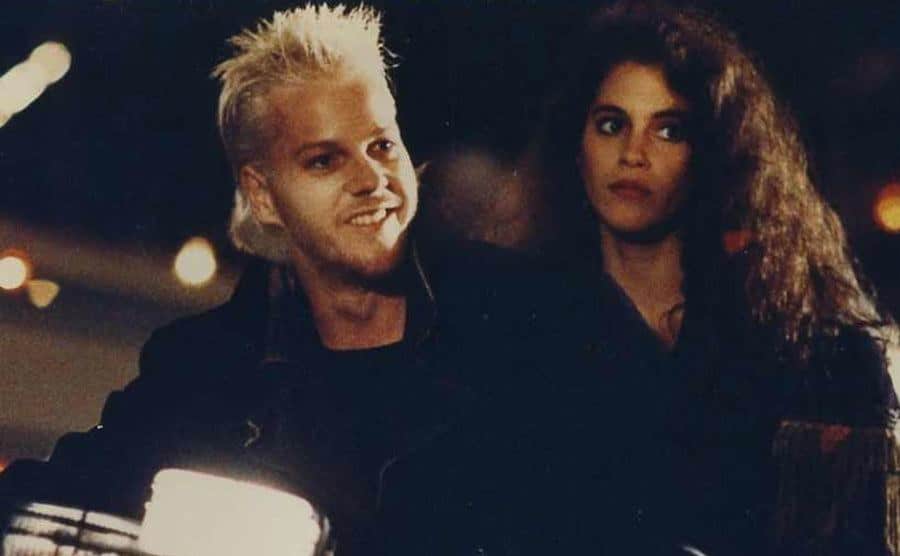 A photo of Kiefer Sutherland and Jami Gertz on set.