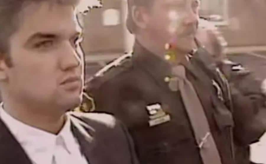 Police handcuff Jonathan Schmitz.