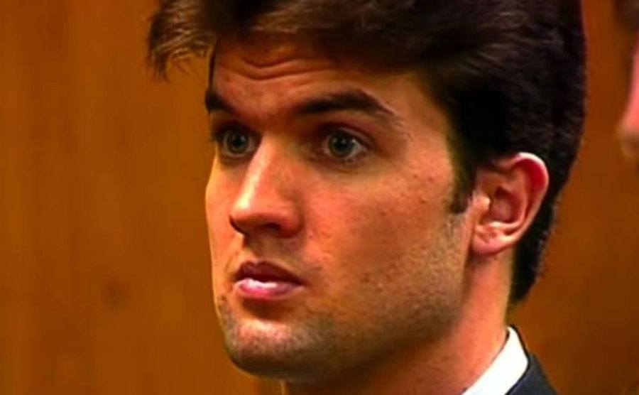 A still of Schmitz standing in court.