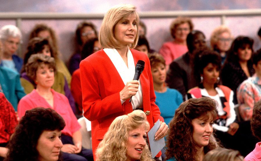 A photo of Jenny Jones standing among the audience members in her talk show.