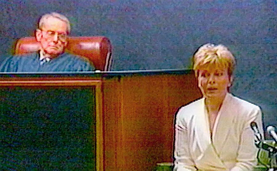 A still of Jenny Jones sitting on the stand during the trial.