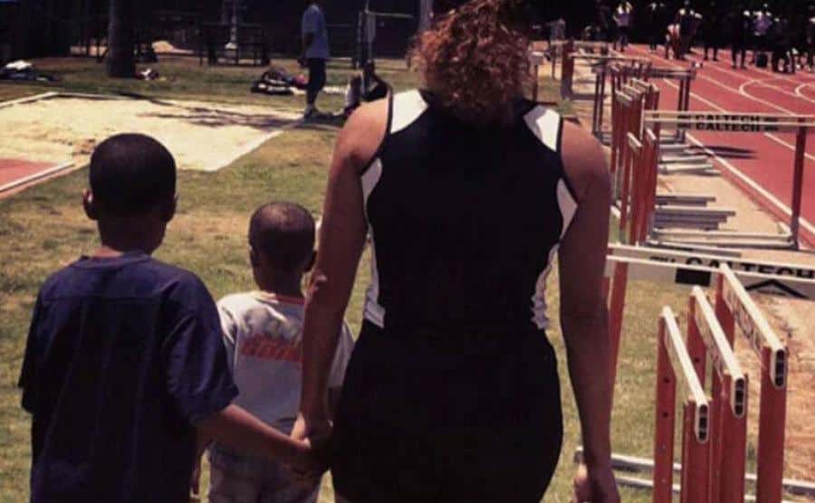 A photo of April with her kids at the park.