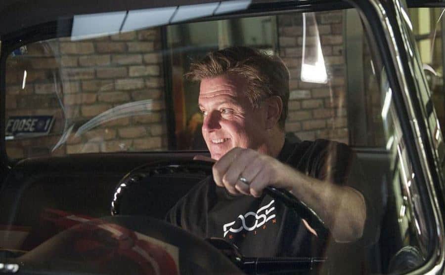 A photo of Chip sitting inside a car.