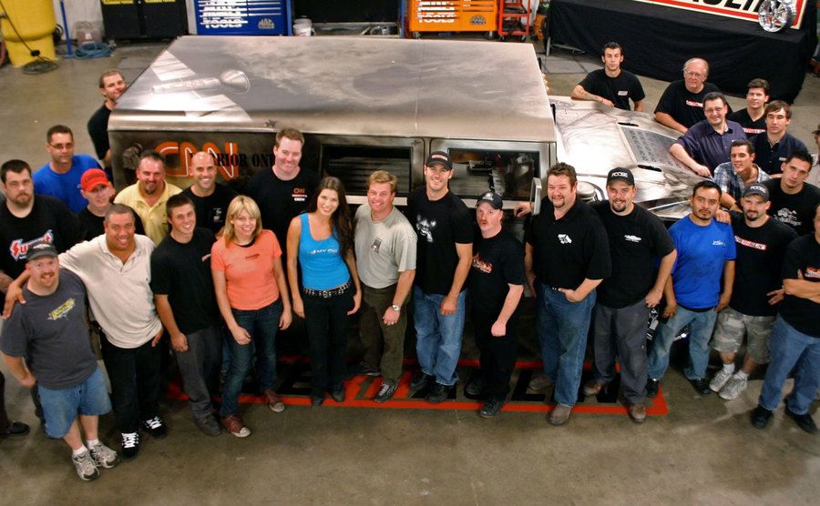The cast and production team pose for a portrait.