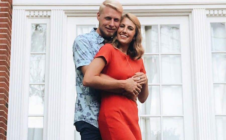 Ethan and Olivia pose for a portrait at their home.