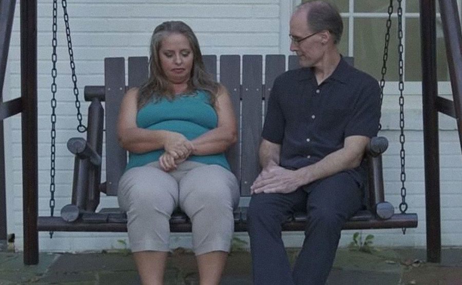 Kim and Barry are sitting on the porch during an episode.