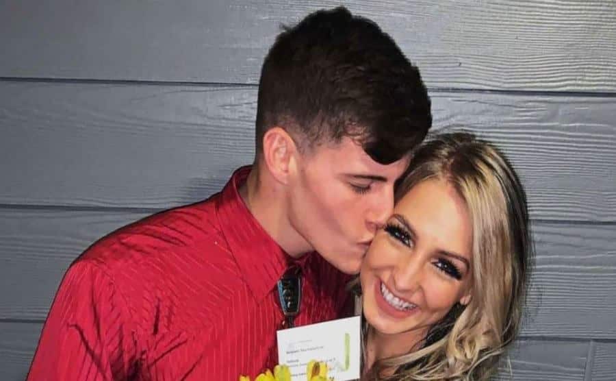 Max kisses Moriah as they pose for a picture.