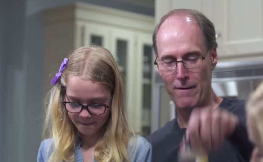 A photo of Barry with his daughters at home.