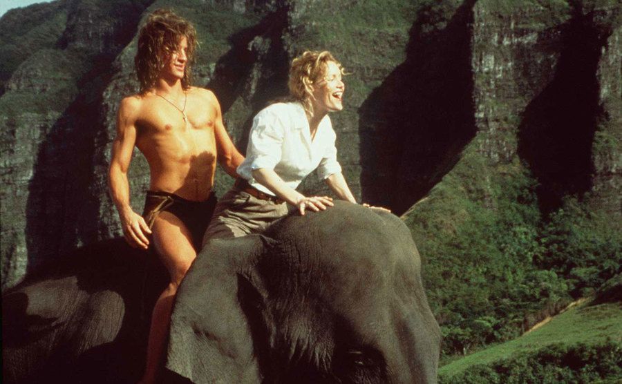 Brendan Fraser and Leslie Mann ride an elephant in a scene from