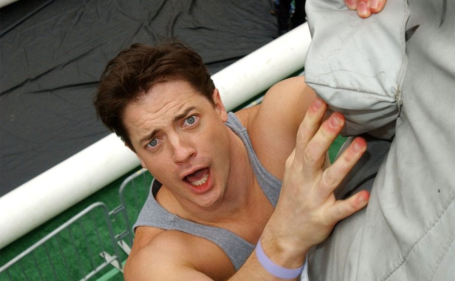 Brendan Fraser climbs the rock wall.