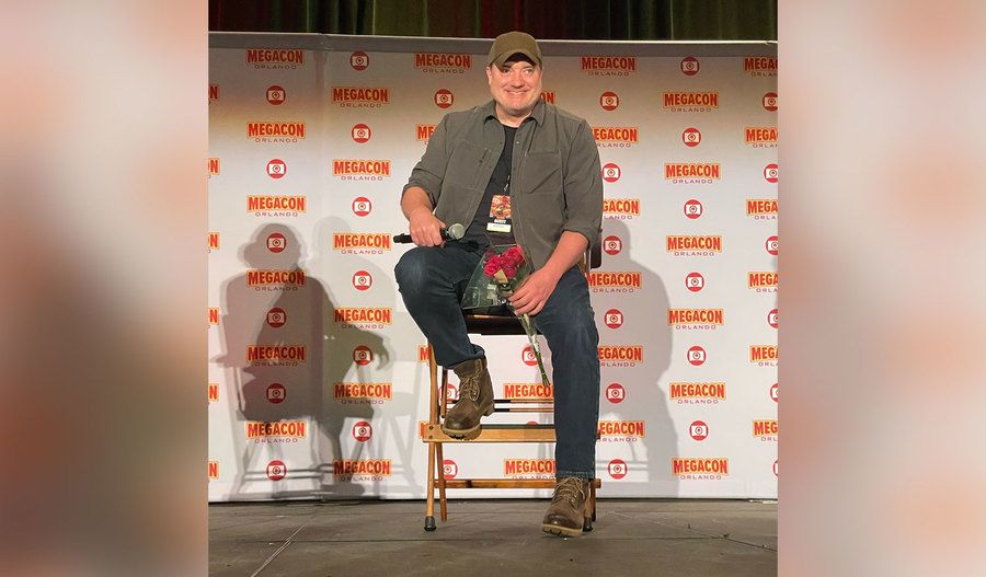Fraser holds red roses during an interview at Megacon.