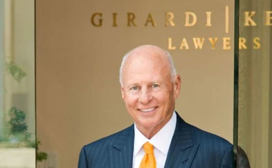 Girardi poses for a professional portrait in his firm.