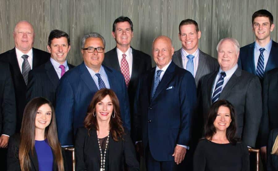A dated image of Girardi with his co-workers at his firm.